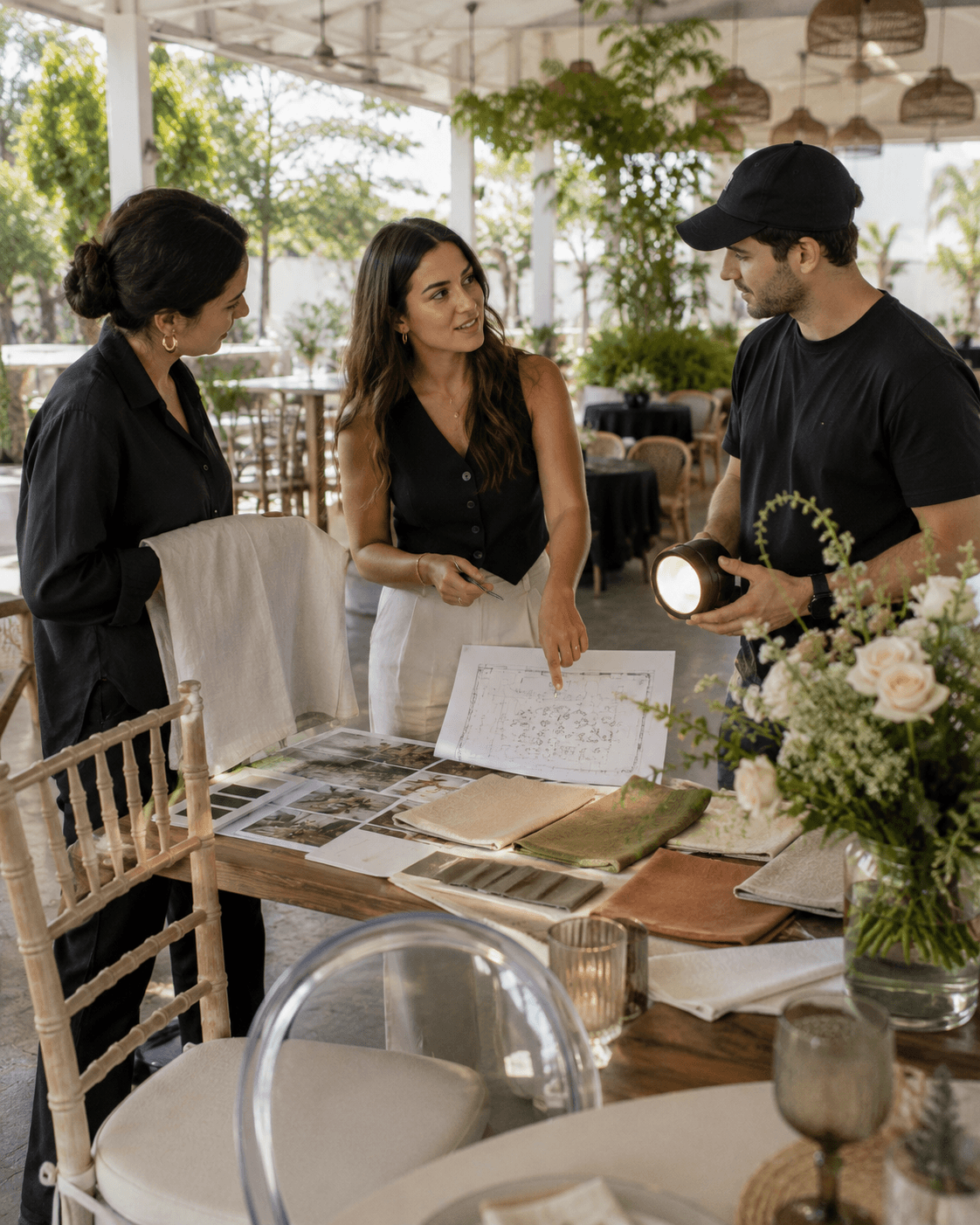 MAREA team curating linens, lighting and floral elements together at the venue